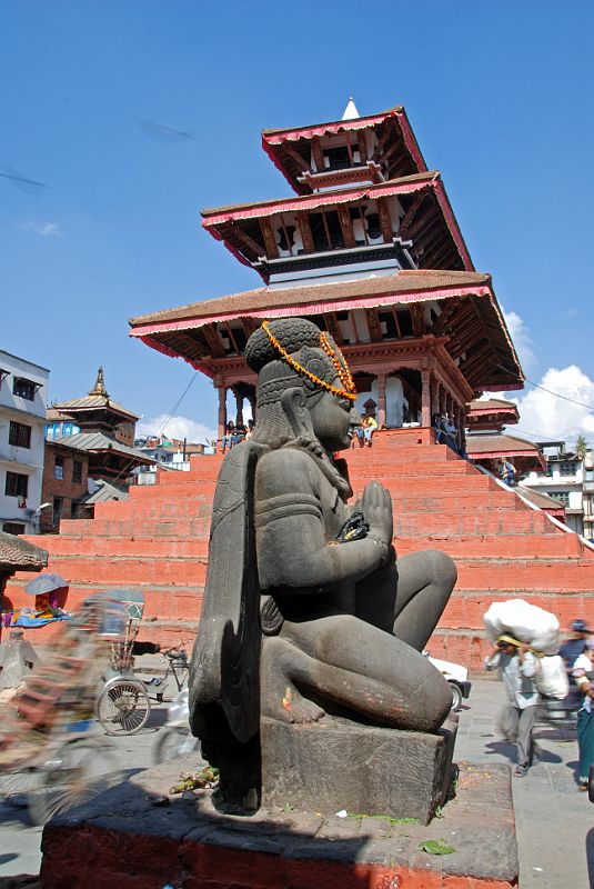Kathmandu Durbar Square 03 03 Garuda Statue And Maju Deval Narayan Temple Garuda kneels with his hands in the namaste position in Kathmandu Durbar Square with the nine-step Maju Deval Narayan Temple to the north.